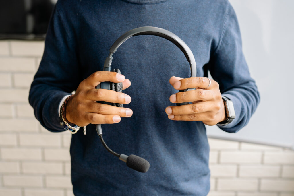 Man holding headphones for voip services