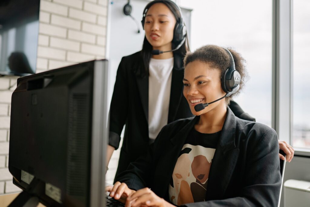 Two women in call center using voip to connect with clients