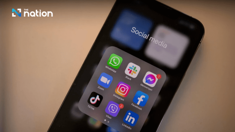 alt text: "Modern office setting in Bangkok with a blurred background and a smartphone displaying digital marketing analytics, symbolizing top social media marketing agencies in Bangkok."