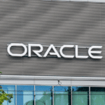 **Alt Text:** "A business professional uses NetSuite AI tools on a laptop, streamlining data entry, pricing, and billing for efficient operations."