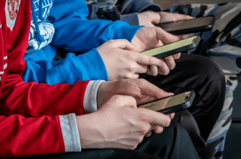 **Alt Text:** "Close-up of a smartphone screen with a suspicious customer service chat, highlighting key safety risks travelers face in 2025, such as phishing scams and data breaches."